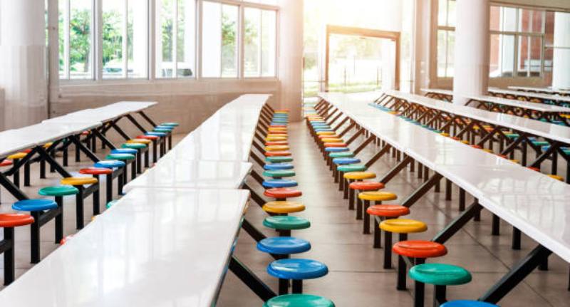 Modern school cafeteria with empty seats and tables